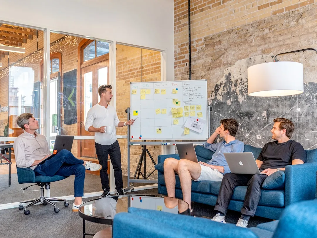 Team collaborating at a whiteboard with sticky notes mapping content stages